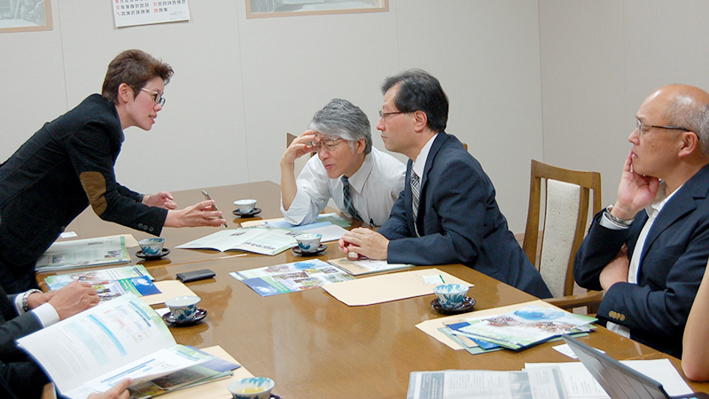 Vice dean Donludee Jaisut (left) showing photos of a soon-to-open dormitory at on campus.