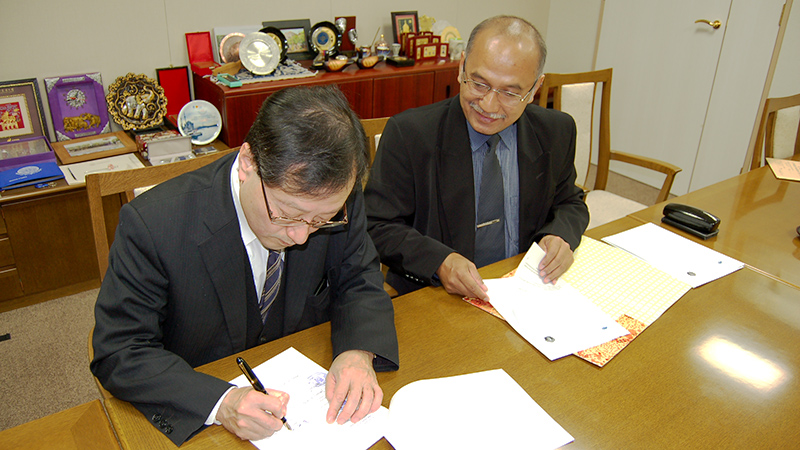 Dean Hisashi Miyagawa signing the agreements
